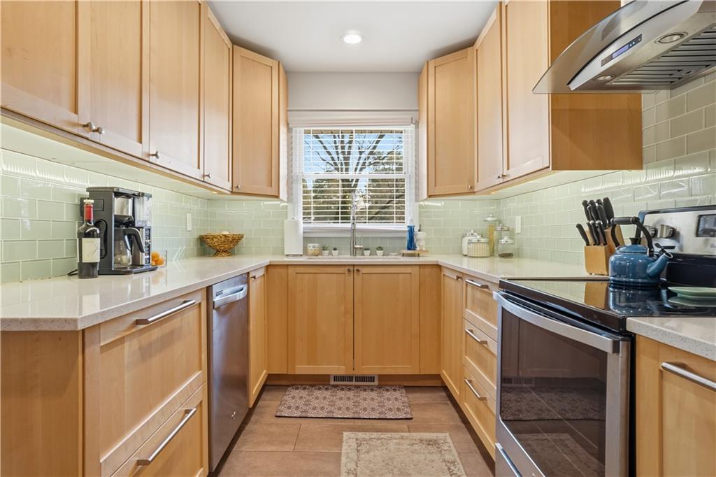 1394 North Druid Hills Road Northeast Brookhaven, GA 30319 - Photo 9 of 38 a kitchen with stainless steel appliances granite countertop a sink stove and cabinets