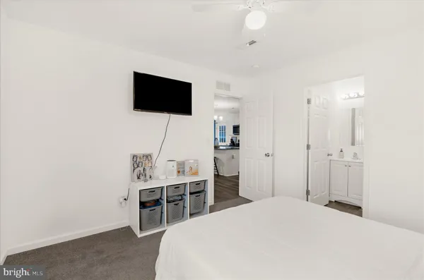 a bathroom with a toilet sink vanity and mirror