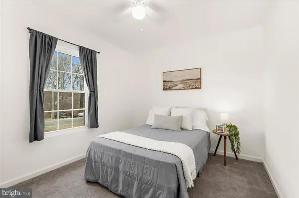 a spacious bedroom with a bed and cabinet