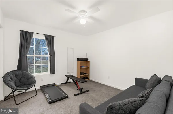 a living room with furniture and a air conditioner vent