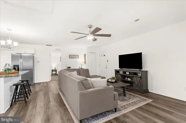 a kitchen with a sink stainless steel appliances and white cabinets