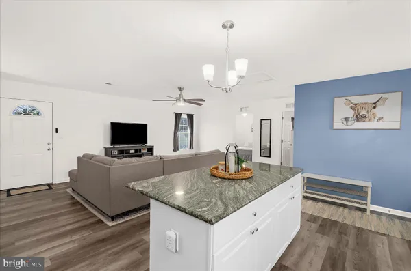 a view of a kitchen with a sink stove and cabinets