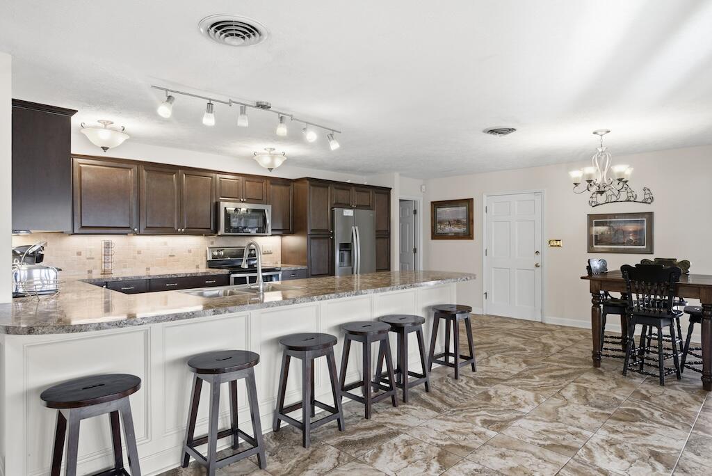 3537 Ferncliff Road Pulaski, VA 24301 - Photo 13 of 50 a large kitchen with a table and chairs