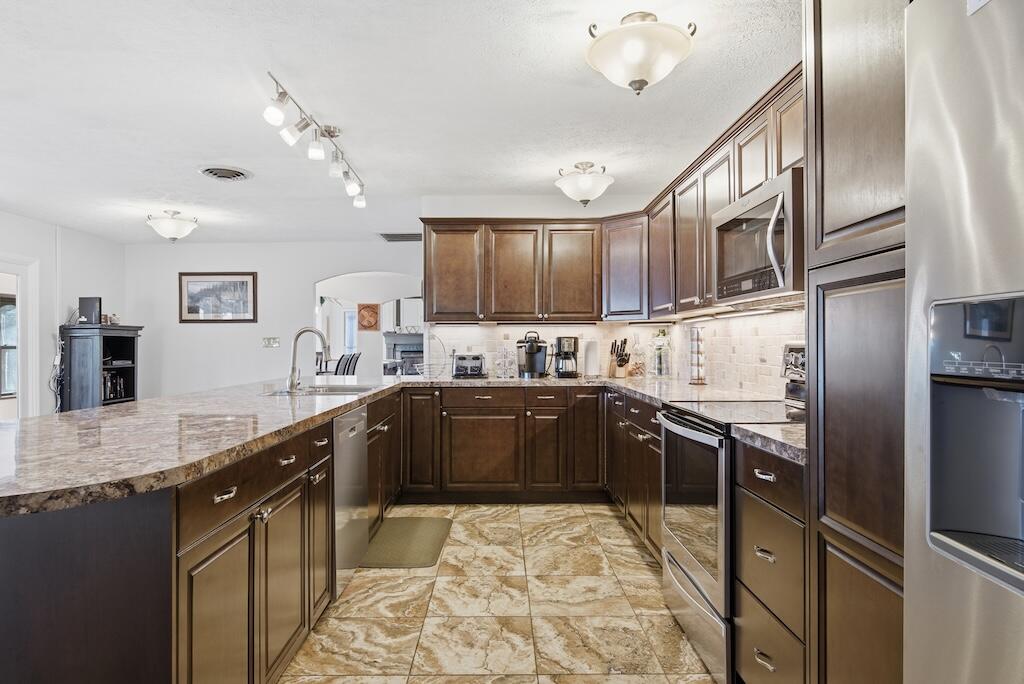 3537 Ferncliff Road Pulaski, VA 24301 - Photo 15 of 50 a kitchen with stainless steel appliances granite countertop a sink refrigerator and cabinets