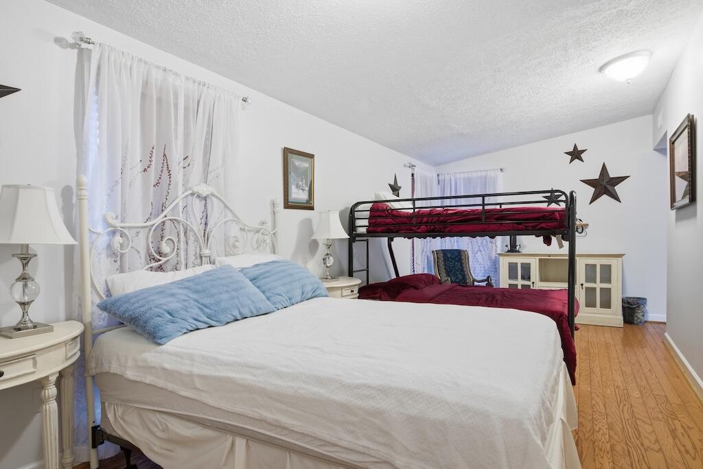 3537 Ferncliff Road Pulaski, VA 24301 - Photo 20 of 50 a bedroom with a bed and a chandelier
