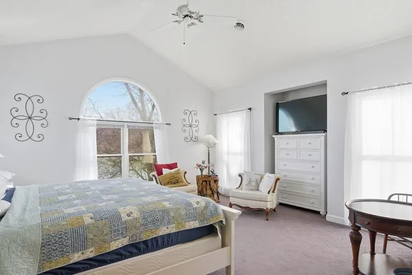 a bedroom with a bed a table and chair