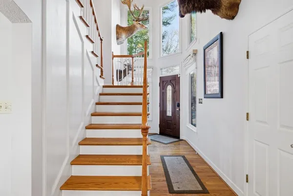 a view of staircase with white walls and a window