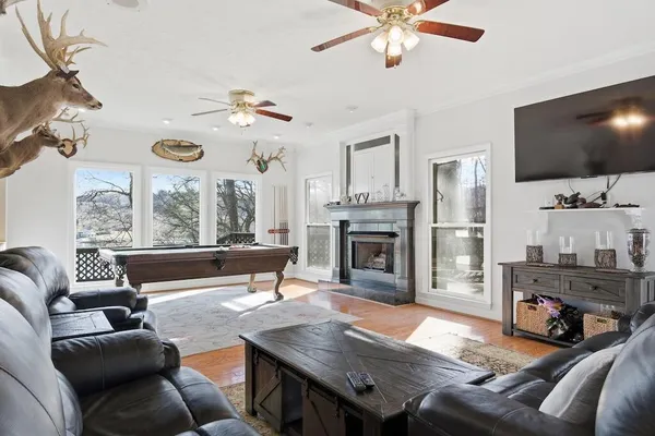 a living room with furniture a fireplace and a flat screen tv
