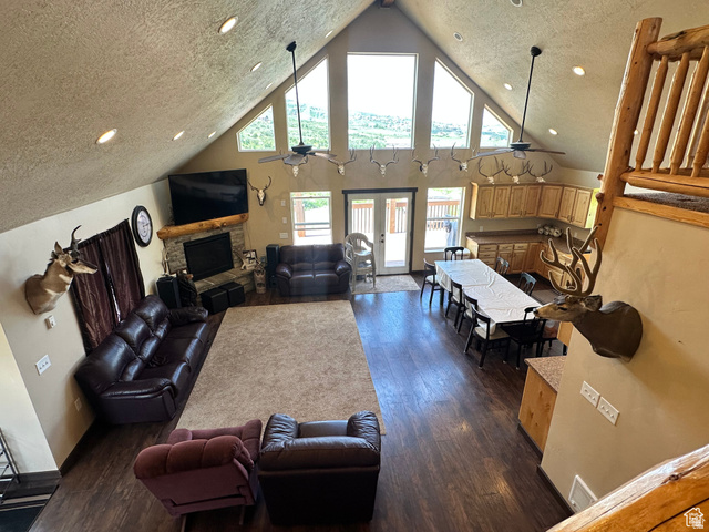 12 Crook Street Fish Haven, ID 83287 - Photo 18 of 35 Living room with a fireplace, a ceiling fan, recessed lighting, a high textured ceiling, and dark wood-type flooring