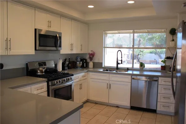 a kitchen with a stove a sink and a microwave