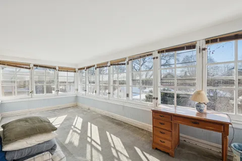 a view of a livingroom with wooden floor and a ceiling fan