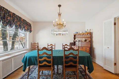 a view of a dining room with furniture wooden floor and a chandelier