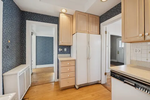 a kitchen with stainless steel appliances a refrigerator and cabinets