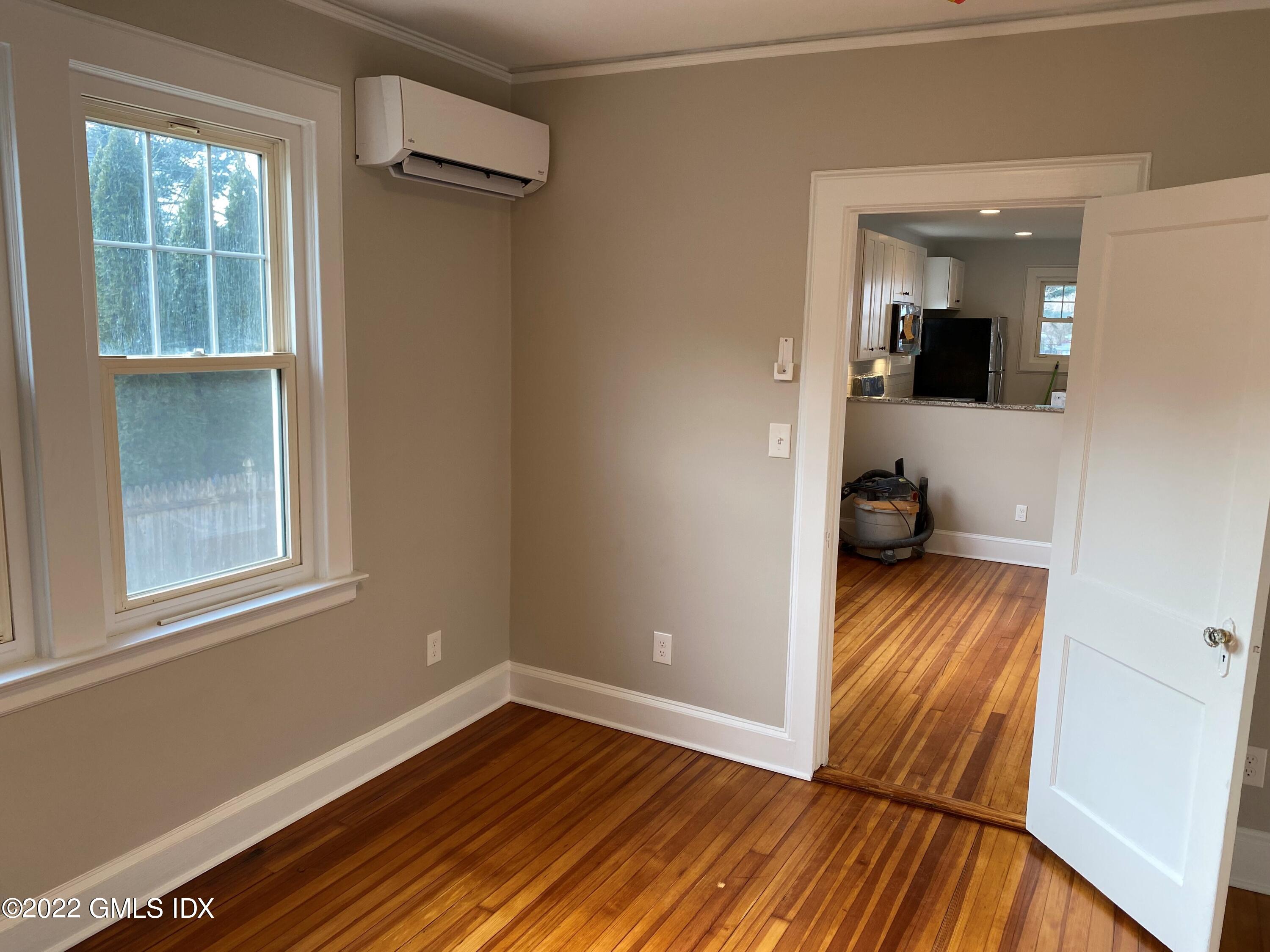 84 Pemberwick Road Greenwich, CT 06831 - Photo 3 of 12 a view of empty room with wooden floor and fan