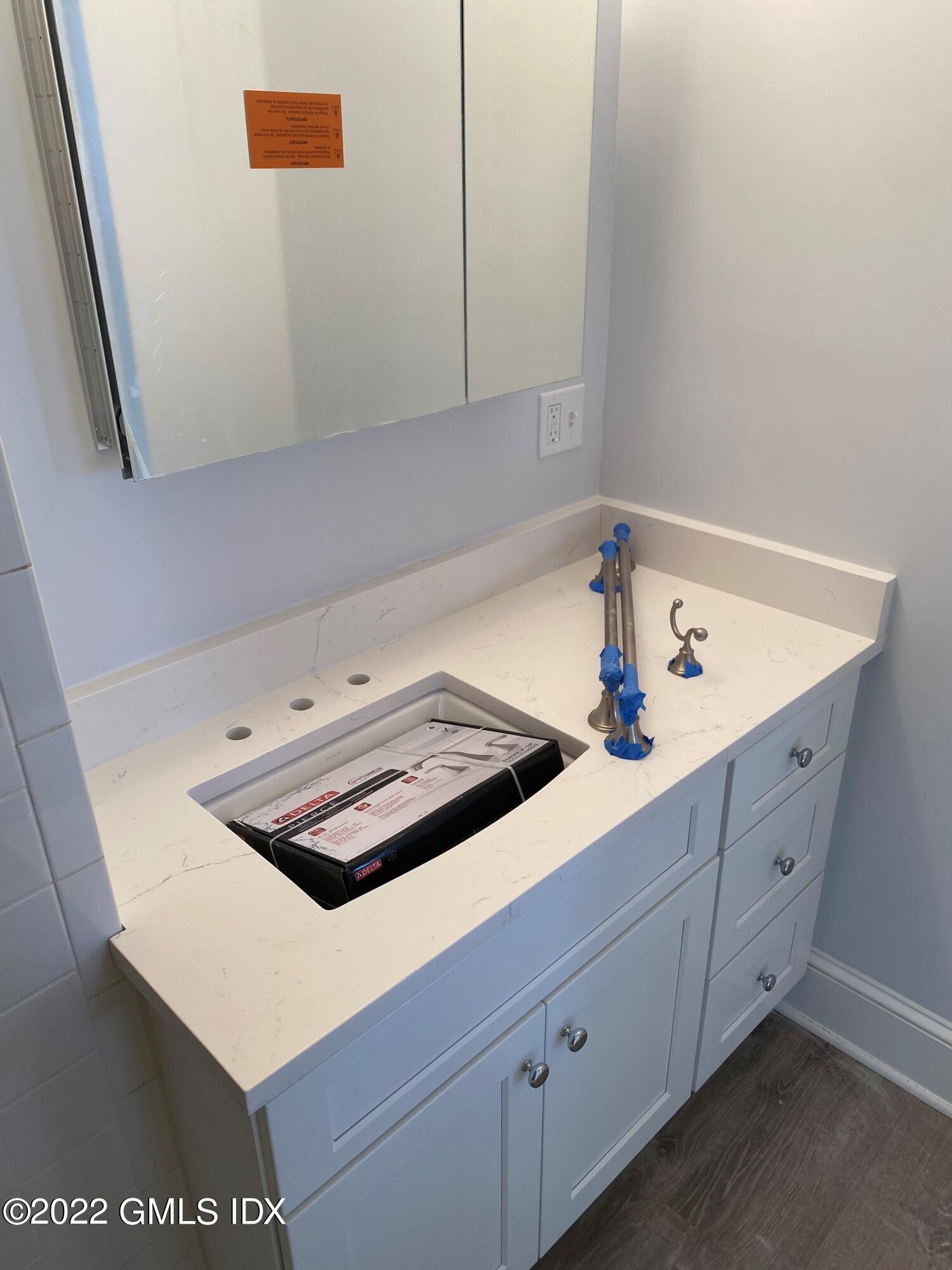 84 Pemberwick Road Greenwich, CT 06831 - Photo 4 of 12 a kitchen with white cabinets and white appliances