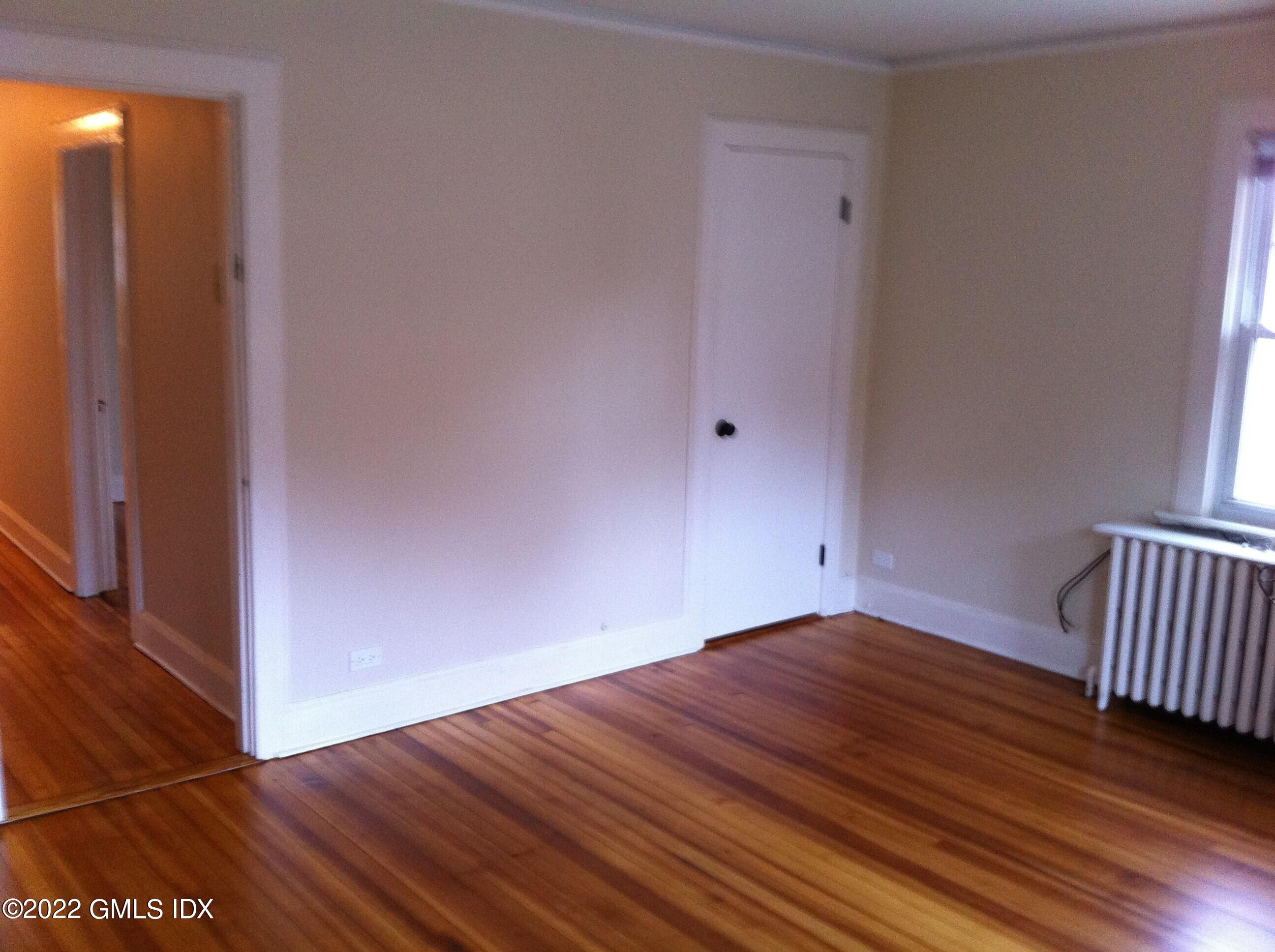 84 Pemberwick Road Greenwich, CT 06831 - Photo 6 of 12 a view of an empty room with wooden floor and a window