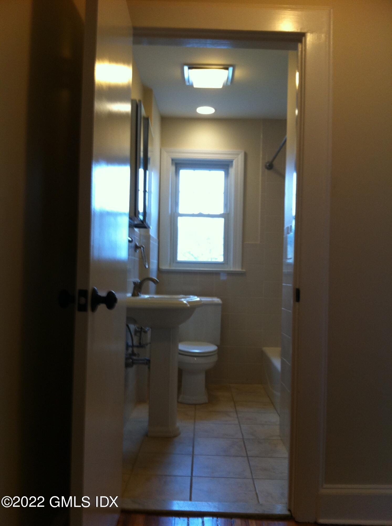 84 Pemberwick Road Greenwich, CT 06831 - Photo 10 of 12 a bathroom with a toilet sink and mirror