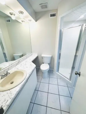 an empty room with windows and ceiling fan