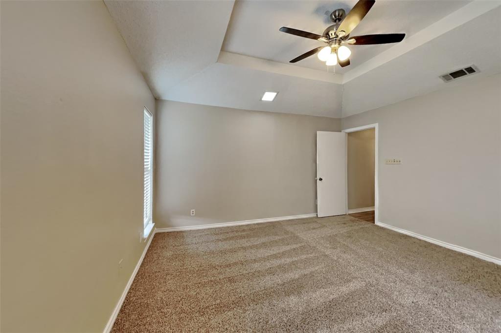 1906 Lavaca Trail Carrollton, TX 75010 - Photo 13 of 31 an empty room with chandelier fan and windows