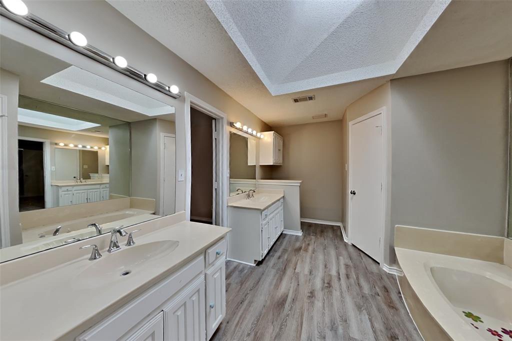 1906 Lavaca Trail Carrollton, TX 75010 - Photo 18 of 31 a bathroom with a sink mirror vanity and bathtub