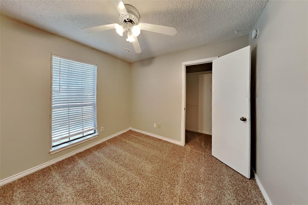 1906 Lavaca Trail Carrollton, TX 75010 - Photo 20 of 31 an empty room with windows and fan