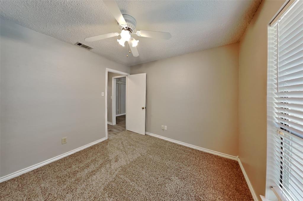 1906 Lavaca Trail Carrollton, TX 75010 - Photo 22 of 31 an empty room with a chandelier fan