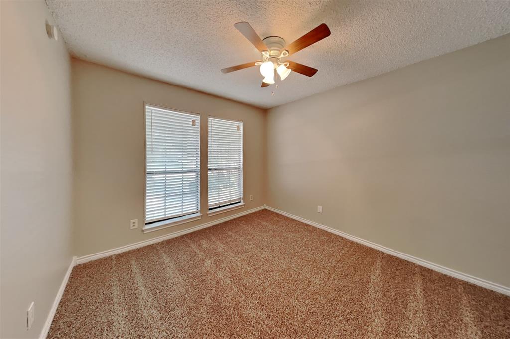1906 Lavaca Trail Carrollton, TX 75010 - Photo 24 of 31 an empty room with windows and fan