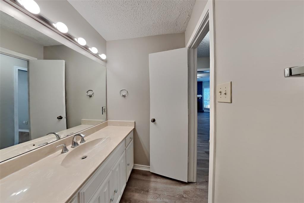 1906 Lavaca Trail Carrollton, TX 75010 - Photo 25 of 31 a spacious bathroom with a double vanity sink and mirror