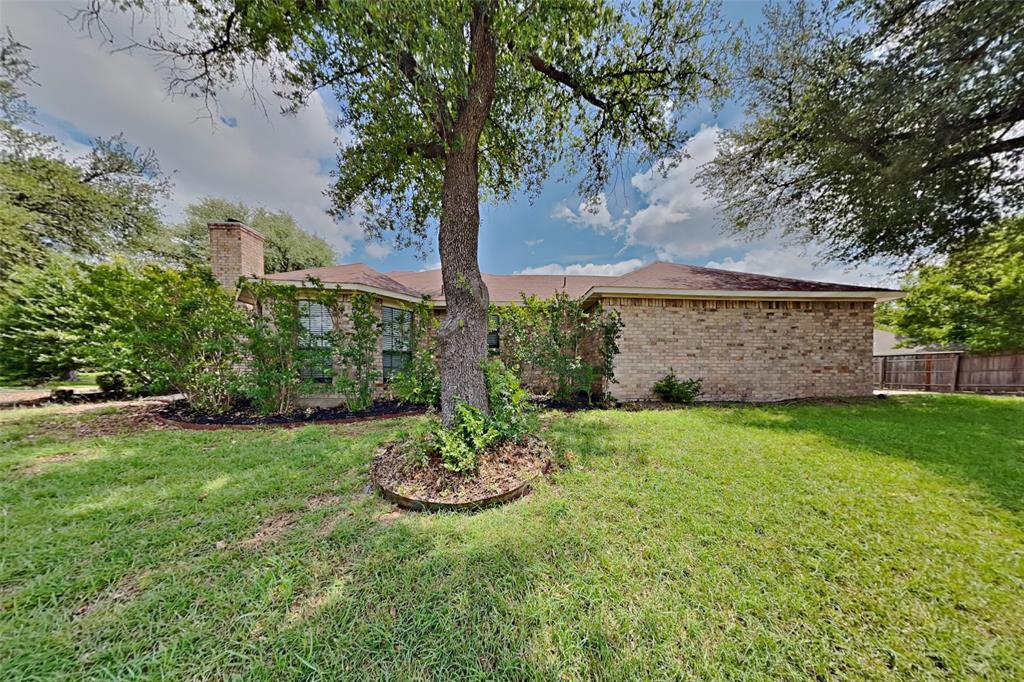 1906 Lavaca Trail Carrollton, TX 75010 - Photo 27 of 31 a view of a backyard with plants and large trees