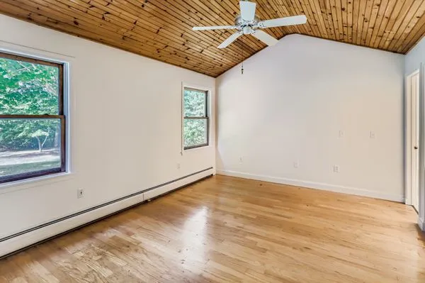a view of a room with wooden floor and windows