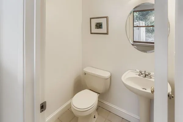 a white toilet sitting next to a bathroom sink