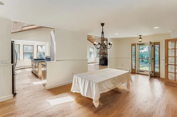 a spacious bedroom with a bed and a chandelier