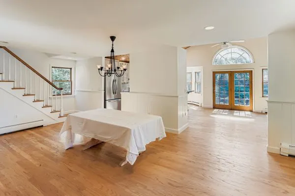 a spacious bedroom with a bed and a chandelier