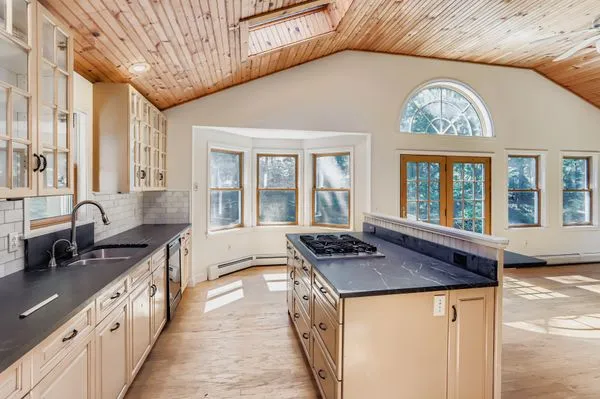 a kitchen with granite countertop a stove and a sink
