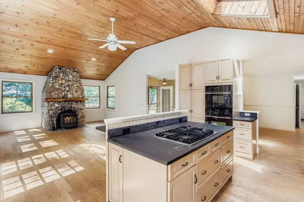 a kitchen with stove and cabinets