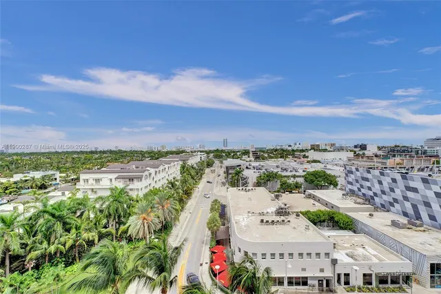 an aerial view of residential houses with outdoor space and trees