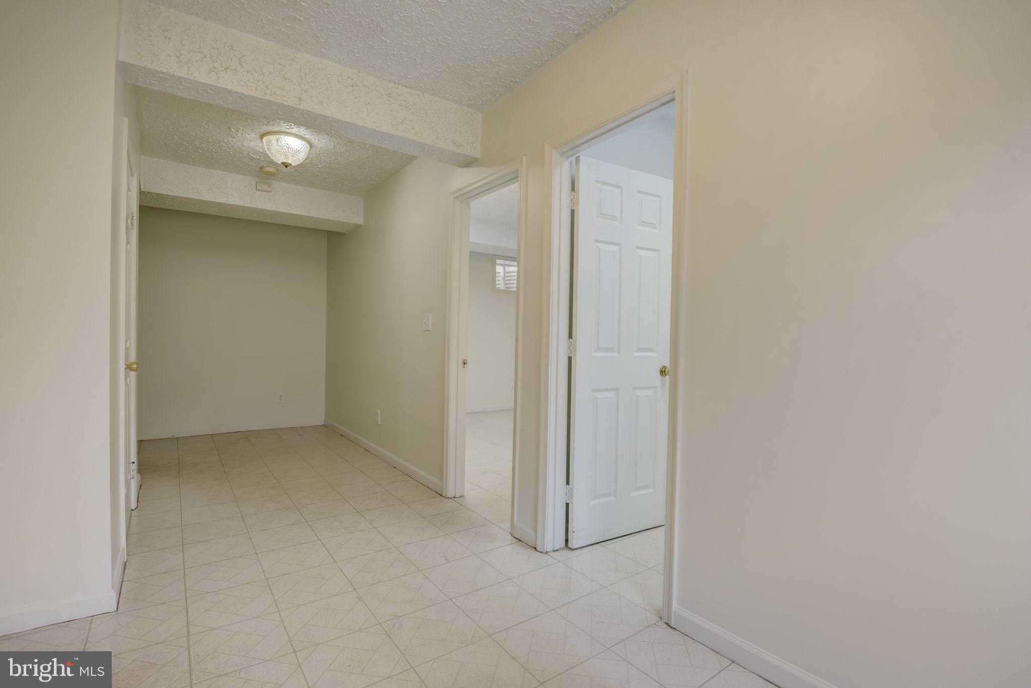 2934 Craiglawn Road Silver Spring, MD 20904 - Photo 23 of 39 23 - Hallway left of stairs with two rooms- Lower