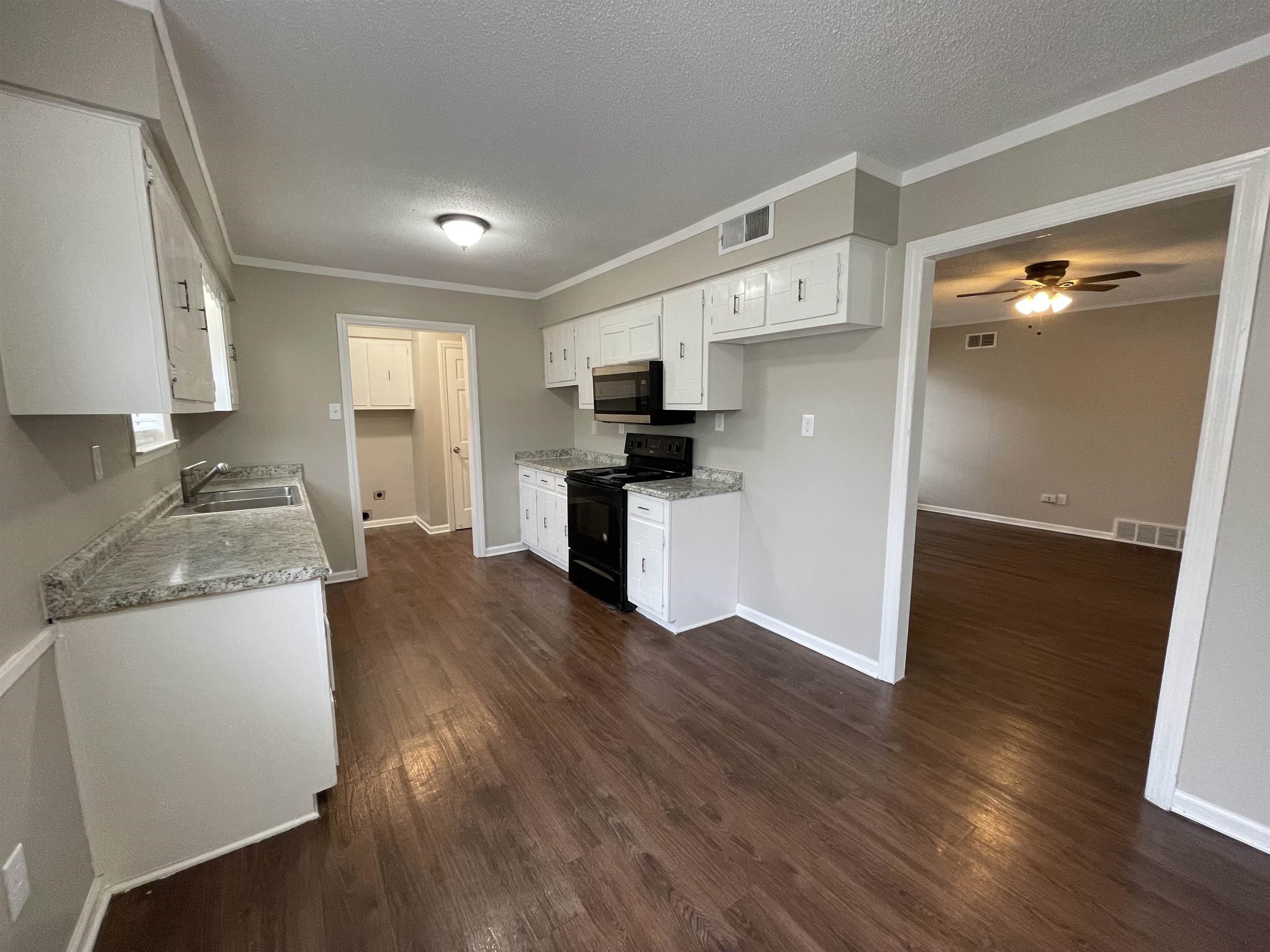 5414 Maple Ridge Road Memphis, TN 38134 - Photo 11 of 23 Kitchen with black electric range oven, dark hardwood / wood-style flooring, white cabinetry, and ceiling fan