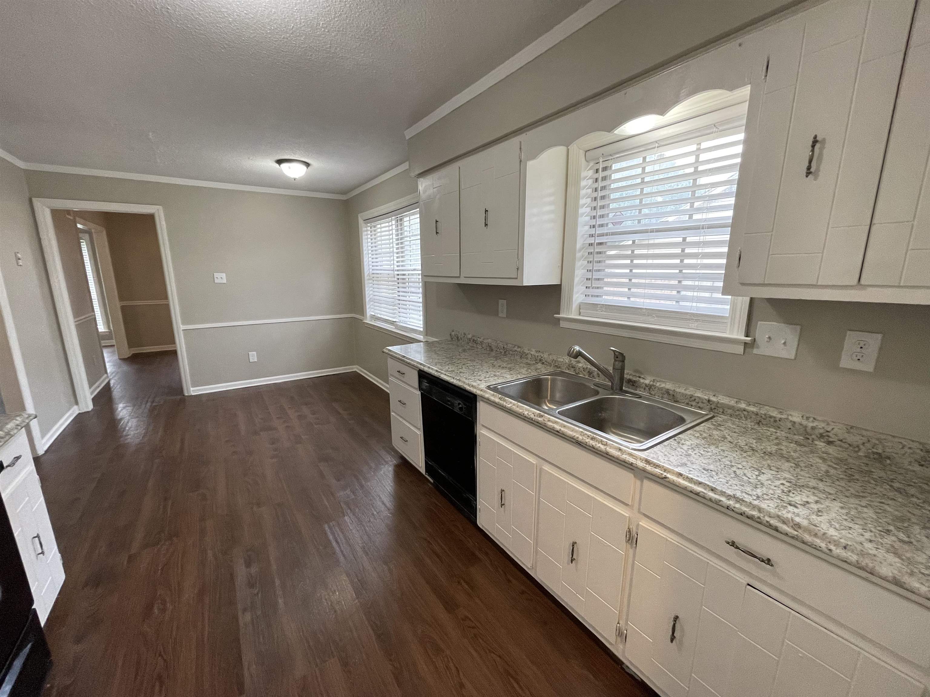 5414 Maple Ridge Road Memphis, TN 38134 - Photo 13 of 23 Kitchen with white cabinets, crown molding, sink, dishwasher, and dark hardwood / wood-style floors