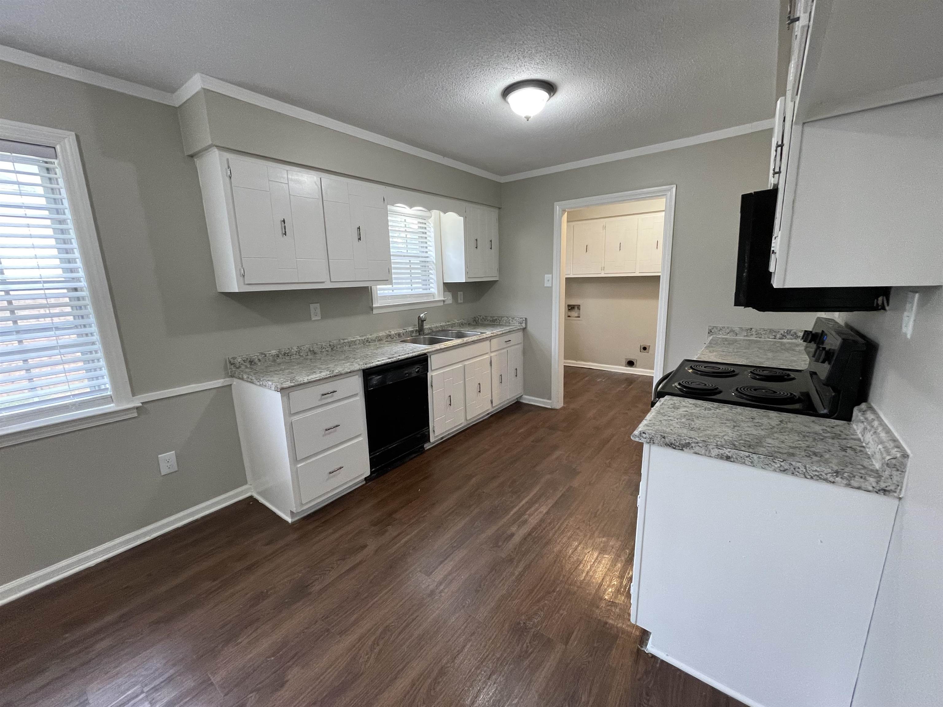 5414 Maple Ridge Road Memphis, TN 38134 - Photo 10 of 23 Kitchen featuring range, dark hardwood / wood-style floors, black dishwasher, and plenty of natural light