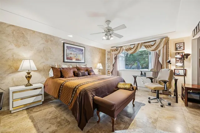 a bedroom with a large bed and a large window