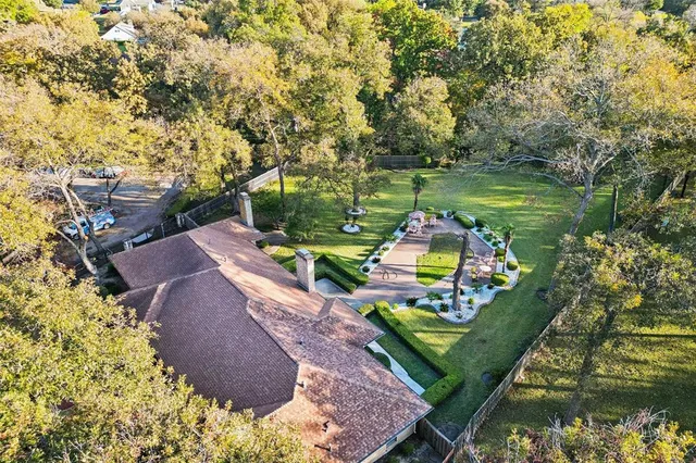 an aerial view of a house with a yard basket ball court and outdoor seating