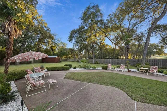 a view of yard with swimming pool and green space