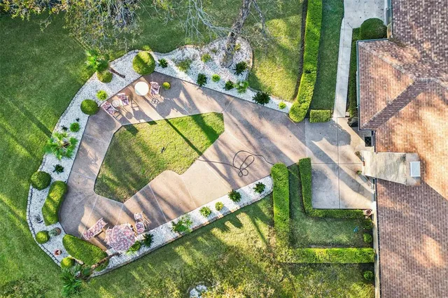 an aerial view of a house with a garden and swimming pool