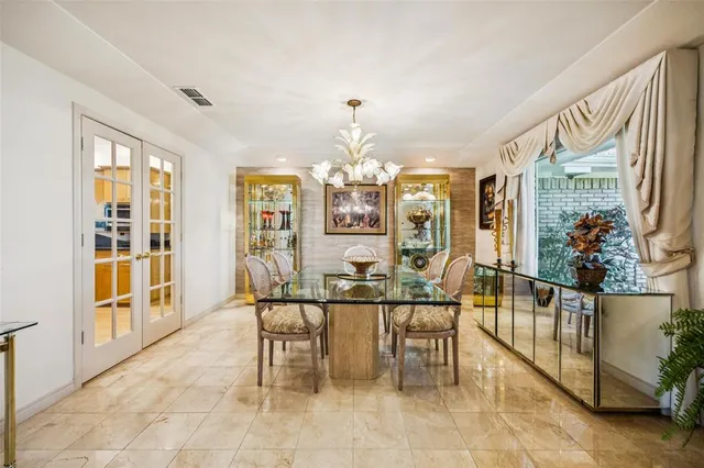 a dining room with furniture and chandelier kitchen view