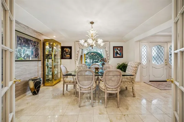 a view of a dining room with furniture and a chandelier