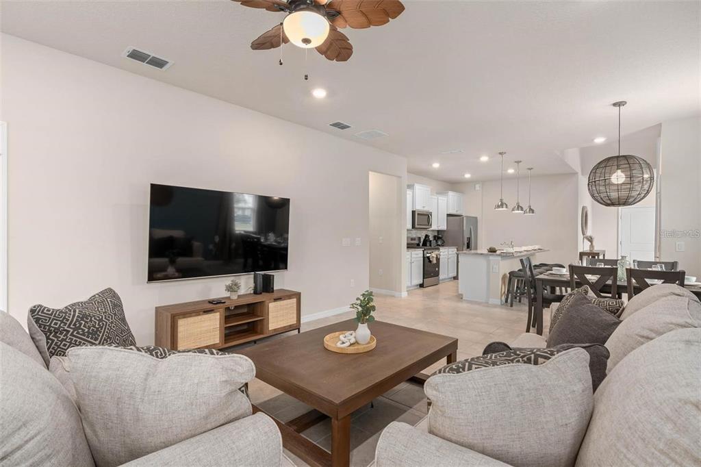 7180 Oakmoss Loop Davenport, FL 33837 - Photo 14 of 29 a living room with furniture and a flat screen tv