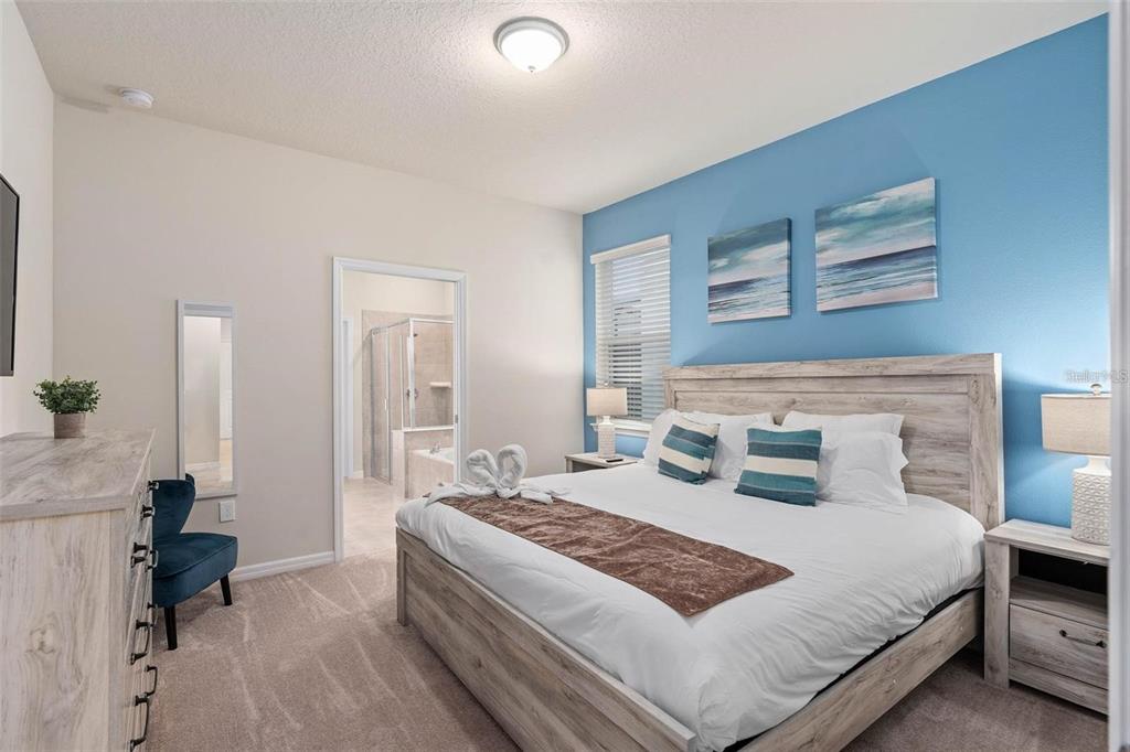 7180 Oakmoss Loop Davenport, FL 33837 - Photo 15 of 29 a bedroom with a large bed and a couch