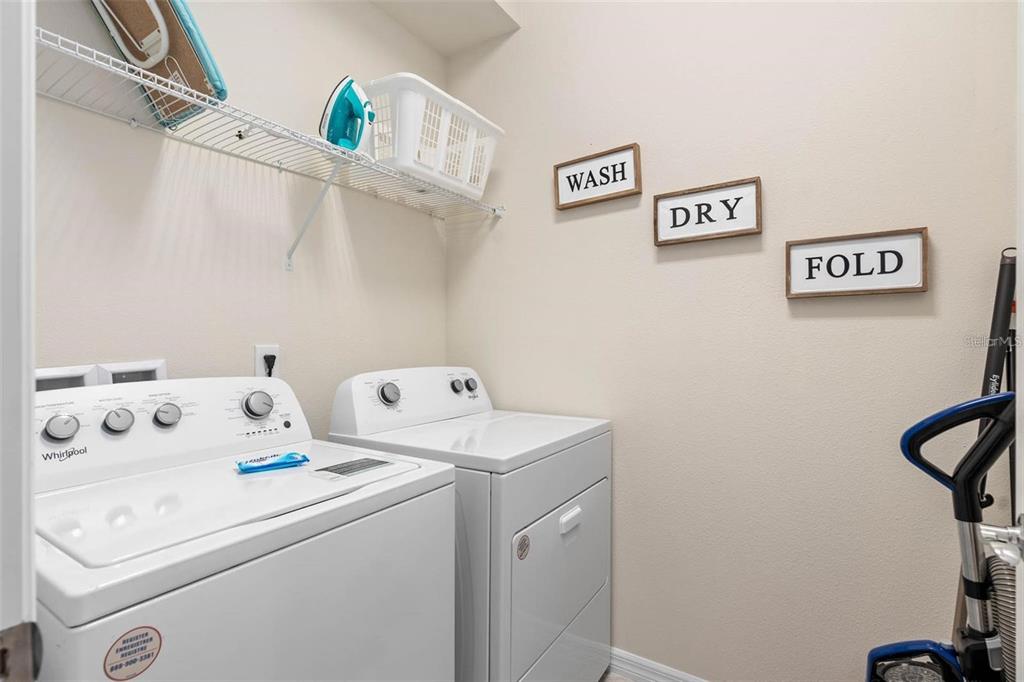 7180 Oakmoss Loop Davenport, FL 33837 - Photo 17 of 29 a utility room with dryer and washer