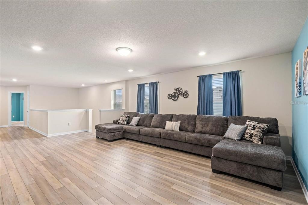 7180 Oakmoss Loop Davenport, FL 33837 - Photo 21 of 29 a living room with furniture and wooden floor